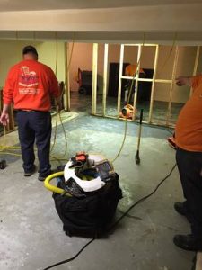 Water Damage Bluffdale Restoration Technicians Cleaning Carpet After A Flood