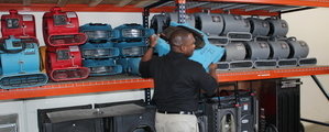 Water Damage Technician Mobilizing Air Movers For Commercial Job