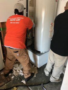 Technicians Repairing A Broken Water Heater